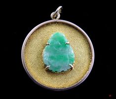 Presented is a nice, 14 karat yellow gold and carved jadeite stone pendant made during the 1920s or possibly the 1930s. The 14 karat gold circle is textured and the center is securely prong set with a hand carved jadeite Buddha. The back is marked 14K. This piece has been tested with nitric acid and is guaranteed to be 14 karat gold purity. This piece is in excellent overall condition. There are no damages and no repairs. The pendant measures 1 1/8 inches in diameter. Weight: 4.3 grams. Art Deco Carved Round Jewelry, Vintage Jade Round Pendant Jewelry, Vintage Jade Pendant Jewelry, Antique Green Jewelry Stamped 14k, Antique Green 14k Stamped Jewelry, Antique Round Jade Jewelry, Collectible Yellow Gold Jade Jewelry, Collectible Jade Pendant Jewelry, Antique Engraved Jade Jewelry