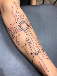 a person's arm with a circuit board tattoo on it