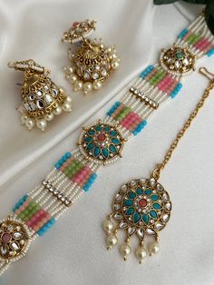 pearl  pastel kundan choker set with tikka set x jhumki lightweight earrings  Style tip- ----------- Pair it with any beautiful traditional outfits  and flaunt with Unique style of collection from us. Perfect match for Festival and Traditional wear.  Take Care Tips-  ---------------- Kee away from perfume, Hair spray and. Moisture.  Store in dry place , Ziplock bag or Airtight box.    Clean with dry cloth.  Jewellery is the last thing you should wear and first thing you should remove.  --------- Multicolor Tilla Choker, Multicolor Choker Jewelry For Diwali, Round Mirror Work Jewelry For Festivals, Round Festival Jewelry With Mirror Work, Festive Multicolor Jewelry With Mirror Work, Multicolor Mirror Work Jewelry Gift, Multicolor Meenakari Choker Jewelry, Adjustable Meenakari Jewelry For Diwali, Multicolor Kundan Choker Necklace