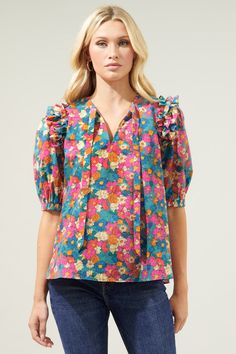 A whole 'lotta lovin' in this groovy blouse. A vintage inspired floral print works to shape the Noche Blouse. Ruffle trim connects voluminous puff sleeves to a relaxed fit, trapeze bodice. A split neckline with a flattering tie detail sits at the center neckline. Style it with denim or tucked into high waisted shorts.- Vintage inspired print- Split neckline- Relaxed fit- Puff sleeves- Color: MultiSize + Fit - Model is 5'8" and wearing size XS- Measurements taken from size S - Chest: 20"- Length: Tie Neck Blouse, Tie Neck, Cotton Style, Ruffle Trim, High Waisted Shorts, Puff Sleeves, Work Outfit, Neck Tie, Puff Sleeve