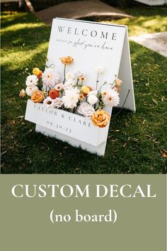 a sign with flowers on it that says, custom decal no board in the grass