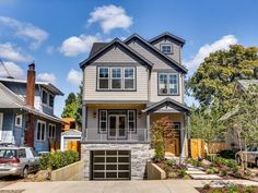 a two story house in the middle of a neighborhood