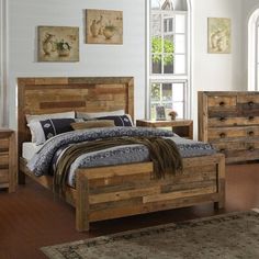 a bed with wooden headboard and foot board sitting in a room next to a window