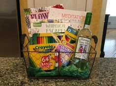 a basket filled with lots of different types of books and drinks on top of a counter