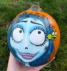 a painted pumpkin with a face on it