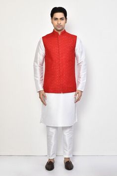 Red silk bundi with all over stripe pattern, tonal thread, sequin embroidery and patch pockets. Paired with full sleeves kurta and straight pant. - Aza Fashions Red Nehru Jacket For Diwali Designer Wear, Red Designer Nehru Jacket For Festive Occasions, Red Nehru Jacket For Festive Designer Wear, Designer Red Fitted Nehru Jacket, Red Fitted Bollywood Nehru Jacket, Red Fitted Nehru Jacket For Designer Wear, Transitional Red Fitted Bandhgala, Fitted Red Nehru Jacket With Zari Work, Red Bollywood Nehru Jacket For Eid