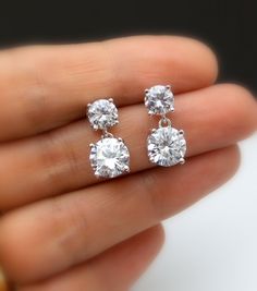 Tarnish resistant White gold plated metal framed AAA high quality clear white cubic zirconia round post earrings with AAA quality round drop clear white cubic zirconia pendant. Earring posts are surgical steel.. Size: top stone diameter: 6mm Bottom stone diameter: 8mm Matching necklace and bracelet available. https://www.etsy.com/listing/278176308/diamond-quality-solitaire-necklace-cubic?ref=listings_manager_grid https://www.etsy.com/listing/85607281/bridal-wedding-bracelet-christams?ref=shop_ho Simple Wedding Earrings, Small Earrings Gold, Diamond Charm Necklace, Diamond Tops, Round Diamond Earrings, Diamond Solitaire Earrings, Diamond Earrings Design, Solitaire Earrings, Jewelry Bridesmaid