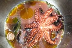 an octopus is cooking in a pot with oil