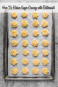 an uncooked pan filled with yellow frosting roses on top of parchment paper