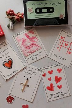 valentine's day cards are laid out on a table next to a cassette player