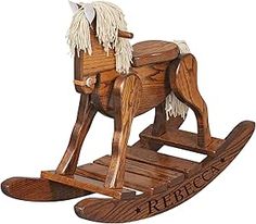 a wooden rocking horse with white manes on it's back legs and feet