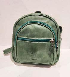 I make these leather backpacks with soft leather. They are small and compact with many compartments to organize yourself. Great for carrying your essential needs. Despite its small size, it is very roomy. Quality zippers and hardware. Fully lined. 5 Zippers. * 3 outside zipper pockets * 1 Zipper main compartment * 1 internal zipper pocket * 1 internal open pocket Dimensions: Height: 25 cm - 9.8 inches Width: 23 cm - 9 inches Depth: 8+2 cm - 3.9 inches FREE SHIPPING TO USA AND TO CANADA! Green Leather Backpack With Zipper Closure, Green Soft Leather Travel Backpack, Green Soft Leather Backpack, Green Soft Leather Backpack For Everyday, Green Leather Backpack For Daily Use, Purse Gift, Women Leather Backpack, Handmade Purses, Purple Bags