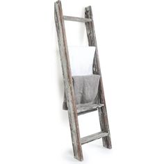 an old wooden ladder leaning against a wall with a towel on it's side