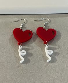 Take a look at these fabulous acrylic red heart earrings. The earrings are made of acrylic. The hooks are stainless steel. The earrings are approximately 2 3/4 inches long. All products are lead, cadmium free, and nickel safe. Thanks for stopping by! This listing is in compliance with Etsy policies. Balloon Earrings, Valentine Earrings, Red Heart Earrings, Valentines Earrings, Heart Balloons, Modern Earrings, Heart Earrings, Red Heart, Statement Earrings