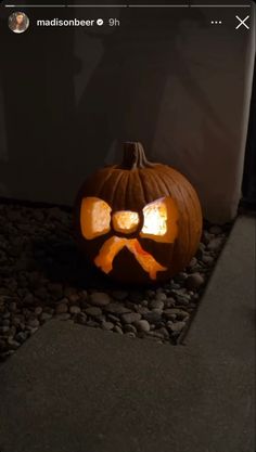 a carved pumpkin with a dog bone on it