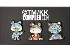 three different animal shaped magnets sitting on top of a black board with the words tmk complexon