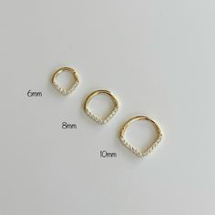 "14k Solid gold Daith or Septum Ring Clicker Features: Sold as a Single - ONE Clicker Material - 14k Solid gold and High Quality Cubic Zirconia Size: 6mm, 8mm, 10mm High Polished Coming with a Gift Box WE CAREFULLY INSPECT ALL OF MY PIECES BEFORE THEY LEAVE THE STUDIO. IF EVER AN ITEM ARRIVES DAMAGED, IT MUST BE REPORTED TO ME IMMEDIATELY- WITHIN 24HRS AFTER DELIVERY. We take all responsibility of BROKEN ITEMS in 5 DAYS AFTER DELIVERY. * Return or Exchange in 14k Solid Gold * 1 - Customer MUST c Everyday Stackable Hoop Septum Ring, Dainty Everyday Septum Ring, Minimalist 14k Gold Hoop Septum Ring, 14k Gold Everyday Septum Ring, Dainty Tarnish-resistant Huggie Rings, Minimalist Gold Piercing With Diamond Cut, Minimalist Yellow Gold Septum Ring For Wedding, Minimalist Gold Diamond Cut Piercing, Everyday Hypoallergenic 14k Gold Septum Ring