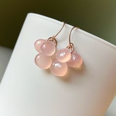 Beautiful pink chalcedony briolettes gather on 14k rose gold filled rings.   Earrings are finished with rose gold filled earwires. Chalcedony hearts measure 9-10mm. Total earring length is 1.25 inches. Please note that pictures of my jewelry are enlarged. The gemstone colors may vary on the device being used to view items. I do not alter the gemstone colors in my photos, but the backdrop can alter their look. My practice is always to add my jewelry last before heading out and to remove my jewelry first after returning home. Here are a few other jewelry care tips: Avoid direct contact with perfume, hairspray or other chemicals. Remove jewelry when bathing, showering or swimming. Remove jewelry when participating in sports and physical activities. Remove jewelry before going to bed. Clean yo Wedding Bohemian, Pink Chalcedony, Bohemian Bridal, Spring Jewelry, Gold Filled Ring, Earrings Pink, Pink Gemstones, Spring Wedding, Gemstone Colors