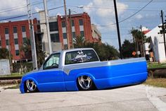 a blue pick up truck parked on the street