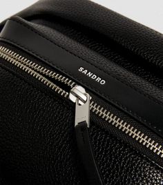 Practicality and elegance, this belt bag by Sandro ensures your day-to-day essentials are always at hand. Crafted with plentiful pockets, an adjustable belt for waist or cross-body wear and leather detailing, it is a sleek and minimal must-have to complete your favourite ensembles. Luxury Travel Belt Bag With Detachable Handle, On-the-go Crossbody Bag With Removable Belt, Sandro Bag, Black Travel Belt Bag With Gold-tone Hardware, Luxury Belt Bag With Detachable Strap For On-the-go, On-the-go Shoulder Belt Bag With Detachable Strap, Leather Detailing, Adjustable Belt, Travel Collection