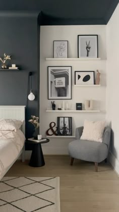 a bed room with a neatly made bed and some pictures on the wall above it