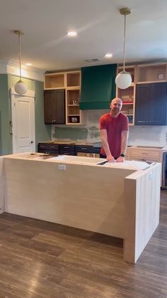 a man standing on top of a kitchen counter