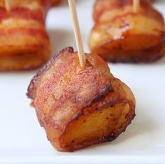 bacon wrapped in toothpicks on a white plate