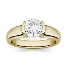 a yellow gold engagement ring with a round diamond