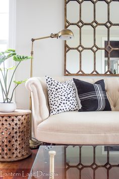 a living room filled with furniture and a large mirror