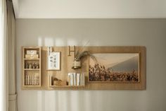 a wooden shelf with books and pictures on it