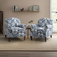 two blue and white chairs in front of a window