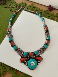 Complement your personality with this trendy unique design.  The gorgeous necklace is beautifully handcrafted by our skilled Indian craftsmen in stones and beads. Material: German Silver.  Weight of the necklace is 130 grams. Turquoise and coral. The length of the necklace when falls on the body is approximately 9 inches  Hook closure Traditional Turquoise Necklace With Colorful Beads For Gift, Spiritual Multicolor Turquoise Necklace For Festivals, Festive Necklaces With Natural Stones For Festivals, Traditional Multicolor Turquoise Necklace As A Gift, Traditional Multicolor Handmade Turquoise Necklace, Festive Turquoise Necklaces With Colorful Beads, Red Bohemian Beaded Necklaces With Stones, Bohemian Red Beaded Necklaces With Stones, Handmade Red Coral Festive Jewelry