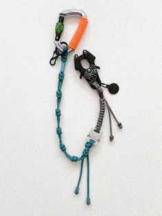 an orange and blue lanyard with some scissors on top of it's cord