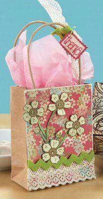 a small shopping bag sitting on top of a table next to some paper doily