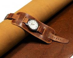 Leather watch strap with leather cuff for women who value quality and comfort. Bund strap is handmade of natural English leather Crazy Cow. This leather is from the legendary Charles F Stead, one of the most respected leather manufacturers in the world. The leather is thick but soft and pleasant to the touch like velvet. When bent, it changes color, the with time becomes even more beautiful. The color is brown with a vintage effect. The cuff definitely added an extra protection for the watch cas Vintage Cuff Bracelet Watch Bands, Vintage Cuff Watch Bands With Bracelet Strap, Vintage Brown Watch Accessories With Wrist Strap, Vintage Cuff Bracelet Strap Watch Accessories, Brown Cuff Watch With Bracelet Strap, Vintage Brown Wrist Strap Watch Accessories, Adjustable Brown Cuff Watch Band, Brown Leather Cuff Watch Band, Brown Adjustable Cuff Watch Band