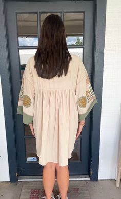 The Asterid Dress is a versatile addition to your wardrobe. Made with embroidered poly linen, it features a V-neck, dropped shoulders, and 3/4 sleeves for a comfortable fit. The embroidery and ruching detailing add a touch of elegance, and the pockets make it functional. With a loose and relaxed fit, it is easy to pull over and wear for any occasion. Chelsea in Black is wearing a size Large. Height is 5’8, Bust is 36”, Waist 28” - 29”, and Hips 42”. Gracie in Teal Rose is wearing a size Small. H Folk Style Cream Dress For Spring, Cream Floral Embroidered Dress For Spring, Cream Folk Dress For Spring, Cream Embroidered Beach Dress For Spring, Spring Beige Embroidered Dress With Embroidered Hem, Beige Long Sleeve Embroidered Dress For Spring, Bohemian Beige Embroidered Dress For Spring, Casual Beige Embroidered Dress For Spring, Spring Beige Dress With Embroidered Sleeves