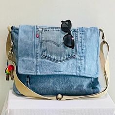 a blue jean purse with sunglasses on it