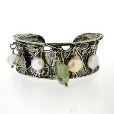 Introducing a unique silver cuff bracelet from Porans collection. This stunning piece features a silver coin, Aventurine bead, and 5 freshwater pearls that dangle elegantly. With its flexible design, it can comfortably fit any wrist. DIMENSIONS - Max Width: 26 mm / 1.04 inches Please contact me with any questions. Visit our silver watches shop: http://www.etsy.com/shop/PoransWatches More of our jewelry: http://www.etsy.com/shop/Porans Follow us: Pinterest - https://www.pinterest.com/porans0483/ Silver Watches, Wide Cuff Bracelets, Silver Coin, Flexible Design, Wide Cuff, Oxidized Silver, Dangle Charms, Silver Cuff Bracelet, Etsy Jewelry