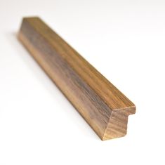 a close up of a wooden object on a white surface