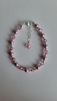 This light pink bracelet is made with Pink Swarovski Crystal Pearls and Swarovski Dark Rose crystal bicones. Each crystal is surrounded by 3mm round sterling silver beads. The Swarovski pearls have a beautiful luster finish. The Swarovski bicone crystals are a new color called Dark Rose and adds even more shimmer to this lovely bracelet. The lobster claw clasp and 1" beaded extention are sterling silver. Custom Orders are always welcome! Ask about free sizing. Elegant Pink Single Strand Beaded Bracelets, Pink Crystal Beaded Bracelets With Faceted Beads, Pink Crystal Beaded Bracelets With Round Beads, Elegant Pink Hypoallergenic Beaded Bracelets, Pink Crystal Beaded Bracelet With Faceted Beads, Pink Beaded Sterling Silver Jewelry, Pink Elegant Single Strand Beaded Bracelets, Pink Single Strand Beaded Bracelet As Gift, Pink Sterling Silver Beaded Jewelry