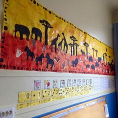 a bulletin board with giraffes and elephants on it