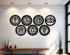 a wall with seven chakras on it in front of a table and window