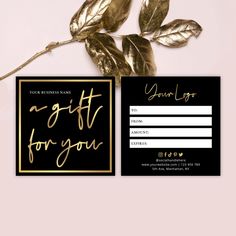 a black and gold gift card with a rose on the side, next to it