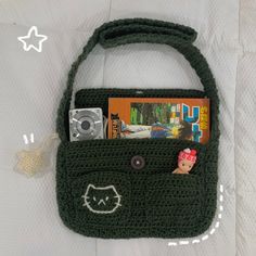 a crocheted purse with a camera and magazine in it