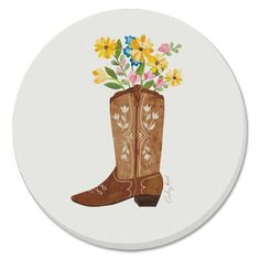 a brown cowboy boot with flowers in it on a white coaster that says, i love you