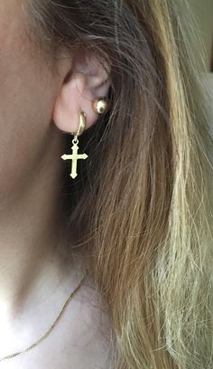 14k gold dangling cross earring ♡ unisex. looks super cool both on men and women shipping: ♡ all listings include free expedited shipping delivers in 2-4 business days care tips : we want you to wear your jewelry for a long long time happily so, to maintain the quality of your new jewelry, please: ♡ do not wear it to the pool, spa, or the beach ♡ remove when sleeping, exercising, or doing other physically strenuous activities ♡ avoid contact with perfumes, body oils, and other chemicals, includi Gold Cross Pendant Earrings As Gift, Gold Cross Pendant Earrings For Gift, Gold Cross Hypoallergenic Earrings, Gold Hypoallergenic Cross Earrings, Gold Cross-shaped Pierced Earrings, Yellow Gold Cross Earrings For Pierced Ears, Minimalist Gold Cross Earrings, Cross-shaped Huggie Earrings For Gift, 14k Gold Cross Earrings