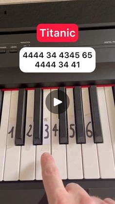 someone is playing the piano with their thumb on it's finger and pointing at the keys