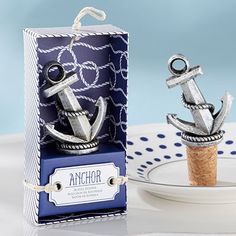 an anchor bottle stopper is sitting on a plate next to a wine cork holder