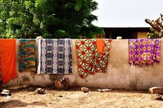 there are many colorful towels hanging on the clothes line