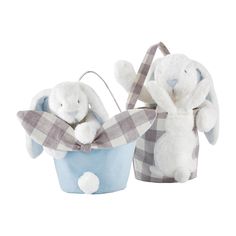 two stuffed animals are sitting in baskets on a white background and one is holding a basket